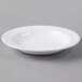 A Libbey white porcelain deep rimmed soup bowl on a gray surface.