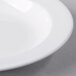 A close up of a Libbey Royal Rideau white porcelain deep rimmed soup bowl.