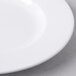 A close up of a Libbey white porcelain plate with a white rim.