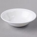 A Libbey Royal Rideau white porcelain grapefruit bowl on a white surface.