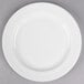 A Libbey round white porcelain plate with a medium rim on a gray surface.
