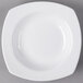 A Libbey white square porcelain deep rimmed soup bowl on a gray surface.