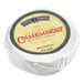 A round white wrapper with a blue and gold label for Eiffel Tower Soft Ripened Baby Camembert Cheese.