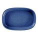 A blue oval porcelain plate with a gold border.