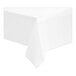 A white plastic table cover roll on a white surface.