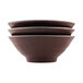 Three Elite Global Solutions Abyss-colored melamine bowls with black and brown designs stacked on top of each other.