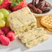 A plate of Coombe Castle Blue Stilton cheese with crackers and fruit.