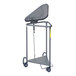 A grey metal triangular hamper with a plastic lid.