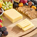 Ammerlander Butterkase cheese and fruit on a wooden board.