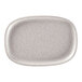 A white oval RAK Porcelain plate with speckled specks.