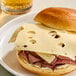 A sandwich with Ammerlander Swiss cheese and meat on a plate.