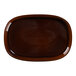 A brown oval porcelain plate with a white background.