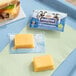 A tray with a sandwich and Beemster Mini Gouda cheese package on it.