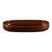 A brown oval porcelain dish with a white background.