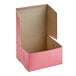 A pink Southern Champion cake box with the lid open.