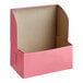 A pink Southern Champion cake box with the lid open.