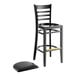 A Lancaster Table & Seating black wood bar stool with black vinyl seat and black footrest.