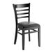 A Lancaster Table & Seating black wood ladder back chair with black vinyl seat