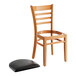 A Lancaster Table & Seating wooden ladder back chair with a detached black vinyl seat.