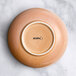 A close up of an Acopa Primrose Pink china bowl with the word "Highlands" on it.