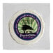 A round white package of Cypress Grove PsycheDillic Goat Cheese with a purple and blue label.