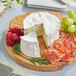 A cheese platter with Cypress Gove Humboldt Fog goat cheese, fruit, and crackers.