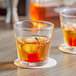 Two Acopa Memphis rocks glasses of whiskey with cherries on top.