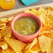 A bowl of Del Sol tomatillo salsa with chips.