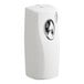 A close-up of a white F-Matic air freshener dispenser with a round button.