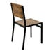 A BFM Seating Chester side chair with a wood back and black legs.