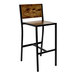 A BFM Seating Chester barstool with a wooden seat and back and black metal legs.