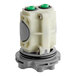 A white plastic American Standard temperature control valve cartridge with green buttons.