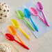 A group of colorful Choice medium weight plastic spoons.