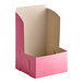 A pink cardboard bakery box with a white lid.