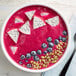 A bowl of pink smoothie with blueberries and dragon fruit.