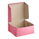 A Southern Champion pink bakery box with the lid open.