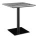 A Lancaster Table & Seating Excalibur table with a black and white marble top.