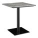A Lancaster Table & Seating square table with a black base and gray textured top.