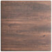 A Lancaster Table & Seating square table with a textured walnut wood surface.
