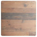 A wooden Lancaster Table & Seating table top with a brown and black textured finish and square base plate.