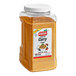 A container of Badia Curry Powder on a table with food.