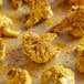 Cauliflower on a baking sheet with Badia Curry Powder.