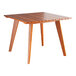 A Lancaster Table & Seating Tigerwood table with wooden legs.