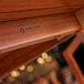 A close up of a wood table surface with a tigerwood pattern.
