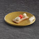 An olive oil-colored Elite Global Solutions round plate with a slice of bread and cheese on it.