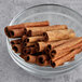 A glass bowl of Badia cinnamon sticks.