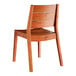 A Lancaster Table & Seating tigerwood table with 2 slat back chairs.