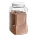 A plastic container of brown Badia Ground Nutmeg powder.