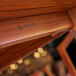 A close up of a wood table surface with a tigerwood finish.