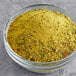A bowl of yellow Badia Mango Pepper seasoning.